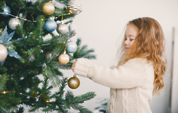 little blonde baby girl helping decorate